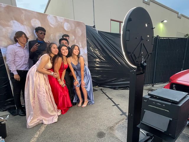 Friends posing at an open-air photo booth at a Sacramento prom