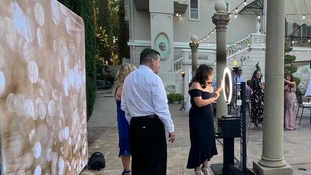 Wedding guests posing at Galaxy's open-air photo booth in Sacramento